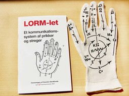 LORM glove and booklet