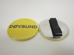 Yellow badge with magnet and the lyrich:DEAFBLIND