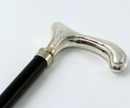Walking stick with silver colored handle