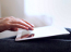 Photo of a person operating a hand-held computer.