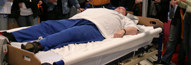 Obese person lying in a bed