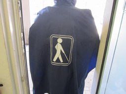 Hooded rain poncho, blue with blind symbol Hooded rain poncho, blue with blind symbol