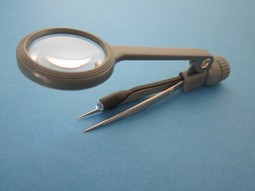 Tweezers with magnifying glass and light. Tweezers with magnifying glass and light.